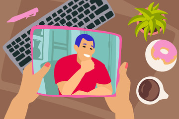 Hand with tab and workspace background. Chatting with friends or family online.