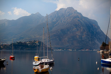 Front View at Como Lake with boats and Big Mountains.  Landscape View at Lecco city, Lombardy, Italy.