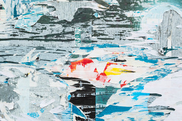 Colorful torn posters on wall