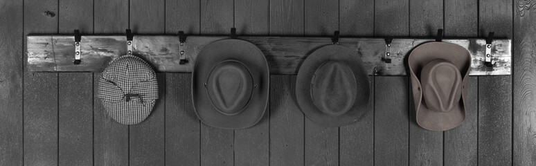 hat on a black wooden hanger on a black wooden wall