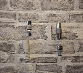 Metal and plastic plug for the antenna in the televisor on the background of a brick wall..