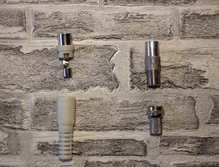 Metal and plastic plug for the antenna in the televisor on the background of a brick wall..