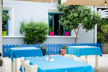 Cozy summer cafe. Tables and chairs on outdoor terrace.