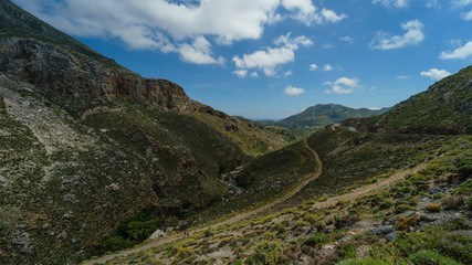 A country road in the valley of the mountains in the summer