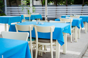 Cozy summer cafe. Tables and chairs on outdoor terrace.