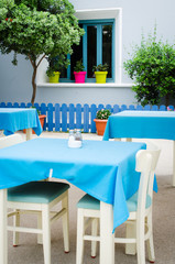 Cozy summer cafe. Tables and chairs on outdoor terrace.