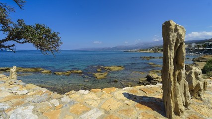 Stone idol on the beach in summer