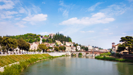 Fototapeta na wymiar Ponte Pietra, Verona, with hill and river, Verona City