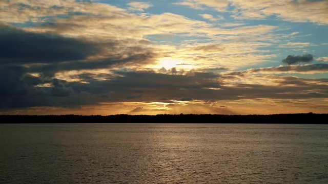 Gorgeous golden sunset on a large river at Alligator Beach near Joao Pessoa, Brazil