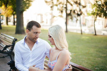 Obraz premium sitting on a bench in the city. couple in love