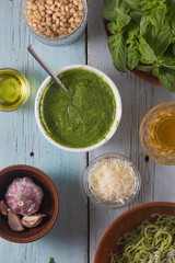 Pasta with pesto sauce italian cuisine, top view, blue wooden background