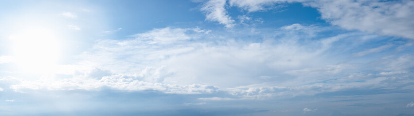 Naklejka na ściany i meble Blue sky with clouds and sun panoramic web banner