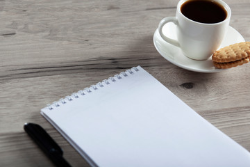 cup of coffee and notepad with color pencils