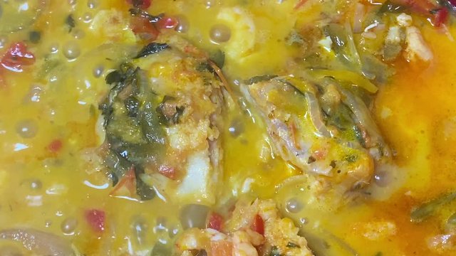 Cooking a moqueca dish. Brazilian traditional food made with fish and shrimp, coconut milk and azeite de dende.