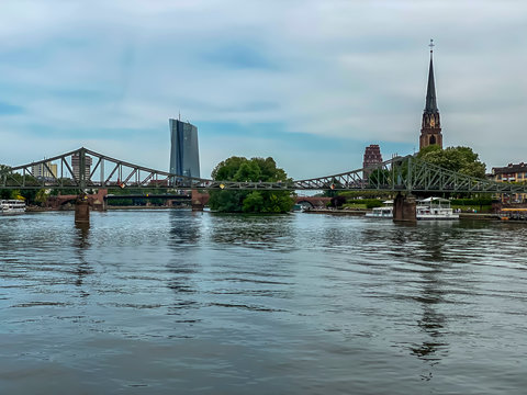 Frankfurt, Germany - 08th May 2020: A german photographer visiting Frankfurt, taking pictures of the historical pedestrian bridge called Eiserner Steg.
