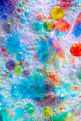 Fototapeta na wymiar Planet Looking Bubbles of Coloured Water on Oil Fantasy Background