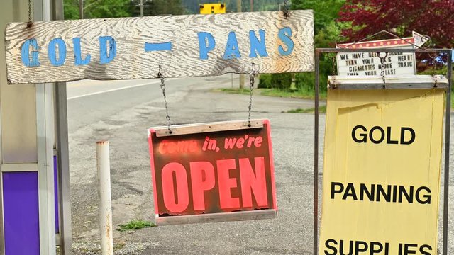 Banner advertising gold panning supplies alongside the gold rush trail at Yale in British Columbia, Canada. It is a dedicated store for those who are dreaming about making a fortune by finding gold.