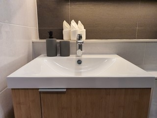 Interior design of villa, house, home, condo and apartment feature basin, White modern wash basin and silver faucet in white toilet. basin for hand wash to protect covid-19(coronavirus)