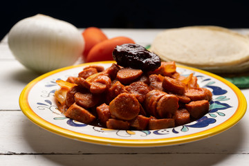 Mexican sausage with chipotle sauce on white background