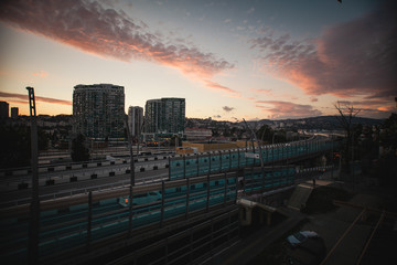 Beautiful sunset in the city of Sochi. Pink sky Bridge, home and evening.