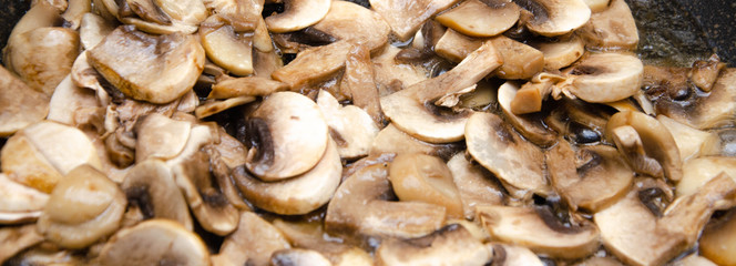 Chopped champignon mushrooms are fried in a pan. Pizza  Mushrooms