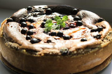 Pie with berries on a white windowsill