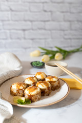Close view on the plate of baked rolls with sauce