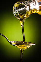 Olive oil flowing to the spoon	