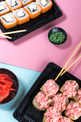 Philadelphia and lava rolls in a black boxes with chopsticks. Food delivery