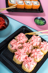 Philadelphia and lava rolls in a black boxes with chopsticks