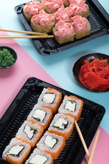 Philadelphia and lava rolls in a black boxes with chopsticks. Food delivery