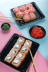 Philadelphia and lava rolls in a black boxes with chopsticks