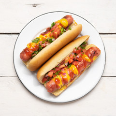 Hot dog with pico de gallo salad on white background