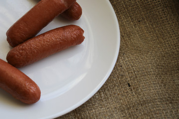 Fried sausages on a white plate