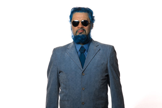 studio portrait of a blue man with a blue beard on a white background