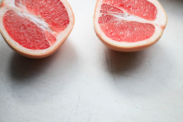 Sliced grapefruit on a light background