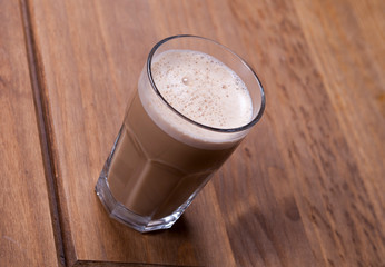 glass of cappuccino on a wooden table