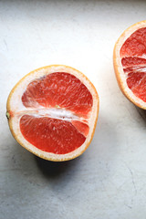 Sliced grapefruit on a light background