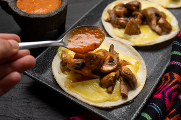 Mexican quesadillas with mushrooms on dark background