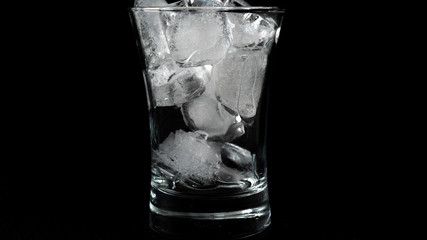 Close-up of melting ice cubes on black background