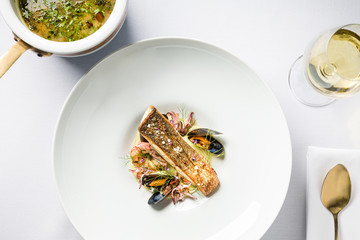Fine dining, French Bouillabaisse fish soup with seafood, fish fillet, shrimp, mussels and white...