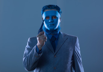 portrait of a strange man in a scary blue mask