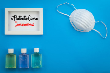 Clean safe healthy living collage flatten the curve concept with mask and hand sanitizer gloves on blue flat lay