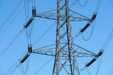 Electricity pylon with blue sky in the background - obrazy, fototapety, plakaty