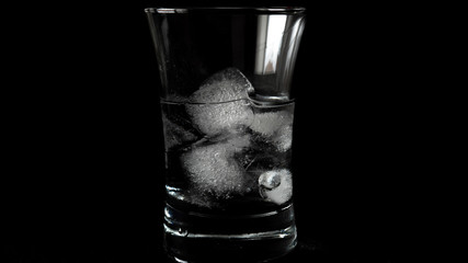 Close-up of melting ice cubes on black background