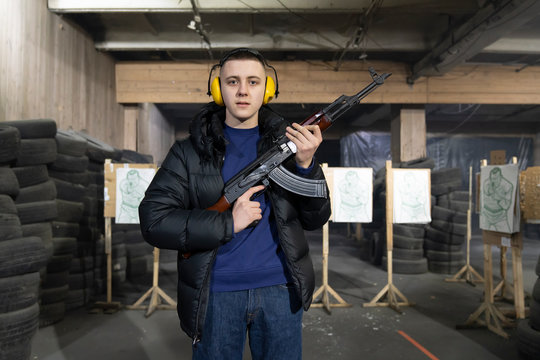 Portrait of young man with a gun in shooting range