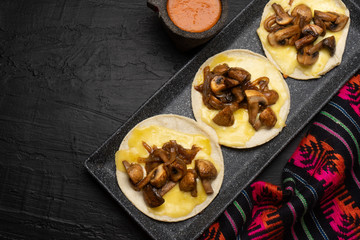 Mexican quesadillas with mushrooms on dark background