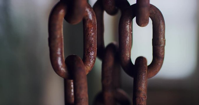 Rusty steel chain hanging. Old metal chain links close-up.