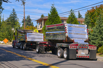Street renovation in the city. Large chrome truck awaiting asphalt unloading.