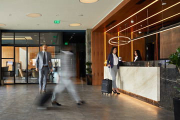 Businesswoman at reception desk in hotel